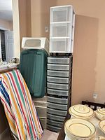 Tall Gracious Living drawer tower, Aero unit above beige drawers, green tote alongside