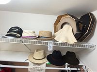 Overview shelf with eight hats and Stetson hat box