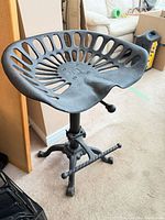 Full view of adjustable cast iron tractor seat stool