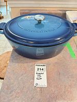 Side view of blue enameled cast iron Dutch oven with lid on