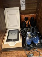 Kindle in box, binoculars in case, two Motorola radios in charger with cables