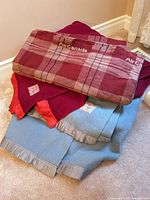 Stack of three wool blankets showing colors and edges