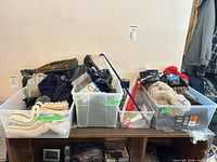 Overview of four bins containing assorted winter accessories