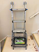 Collapsed aluminum ladder with step stool nested in front