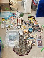 Wide view of all sewing notions, books, tools and patterns laid on floor