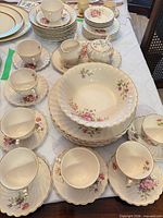 Full view of stacked dinnerware set on table showing quantity and pattern
