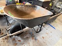 Left side view showing metal tub, pneumatic wheel, wood handles