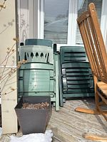 Front view of stacked green plastic chairs on deck