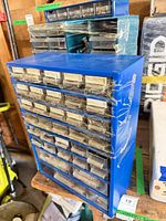 Front view of blue cabinet showing drawers and labels