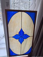 Full view of stained glass panel hanging in window