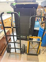 Both hand trucks side by side showing size difference and overall condition