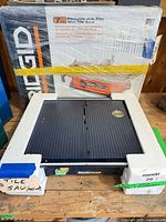 Front view of Mastercraft tile saw with Ridgid boxed saw behind