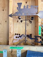 Full view of locomotive weathervane on shelf