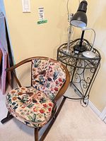 Rocking chair beside iron side table and desk lamp