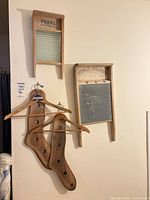 Full lot hung on wall: both washboards, both stretchers, two hangers visible