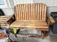 front view of wooden 2-person glider bench
