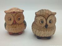 front view of both carved wooden owl figurines