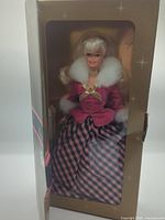 Doll in partially opened front of gold box