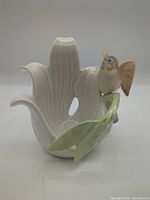 Full view of porcelain flower candle holder with bird