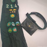 Full view of sash with badges and belt with coin pouch