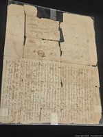 Front view of entire damaged letter showing tape repairs and missing sections