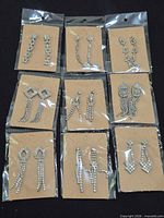 All nine pairs of rhinestone earrings on kraft cards