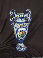 Full view of blue and white floral vase with handles