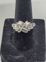 Front view of silver plated Avon ring on display cone