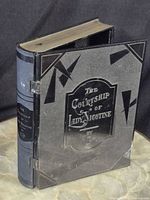 Closed humidor showing front cover and gilded page edges