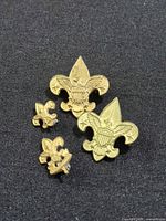 Four of the brass BSA pins showing both size variants
