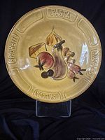 Front view showing entire bowl, molded rim lettering and painted motif