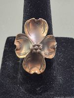 Front view of copper flower ring on display stand