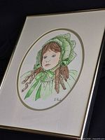 Full view of framed illustration print with gold trim