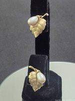 Full view of both earrings on display stand
