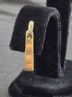 Front view of single earring on stand