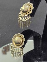 Pair of earrings on velvet stand, full view