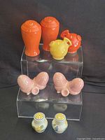 Full lot showing pair of floral shakers at bottom of display