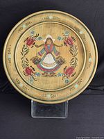 Full view of round wooden tray showing painted design