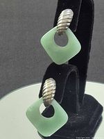 Front view of pair showing jade squares and silver ribbed tops