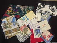 All handkerchiefs laid out showing variety of prints and embroidery
