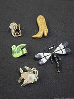 Group image showing all five brooches