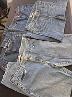All four denim shorts folded in stack