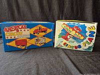 Front view of both original boxes: American Circus truck set and Circus Plane