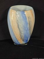 Front view of swirled blue, orange, white art glass vase