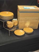 Overall lot with stacked dinner plates, cups and original Noritake shipping box