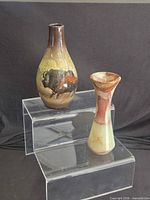 Both vases side by side on acrylic risers