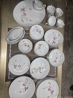 Full dinnerware set laid out on table