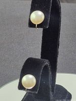 front view showing both pearl studs mounted on display