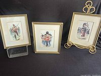 All three framed prints standing on display