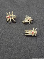 All three insect brooches on black fabric
